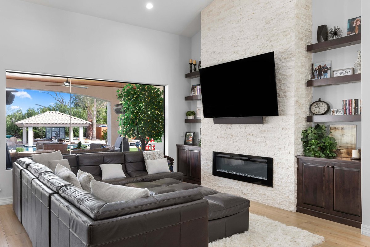 Custom entertainment center with built-in storage and fireplace in Gilbert home